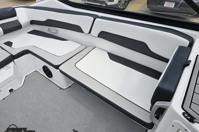 Slide: The Image of 2022 Yamaha Boats AR195 interior seating with sleek black and white design. - 81