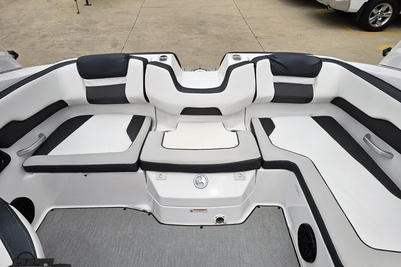 Slide: The Image of 2022 Yamaha Boats AR195 interior seating with sleek black and white upholstery. - 82