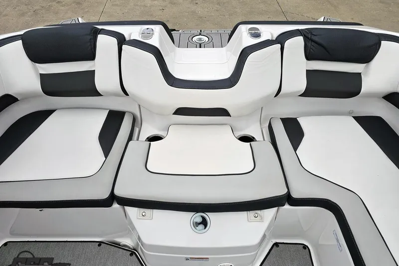 Slide: The Image of 2022 Yamaha Boats AR195 interior seating with sleek black and white upholstery design. - 83