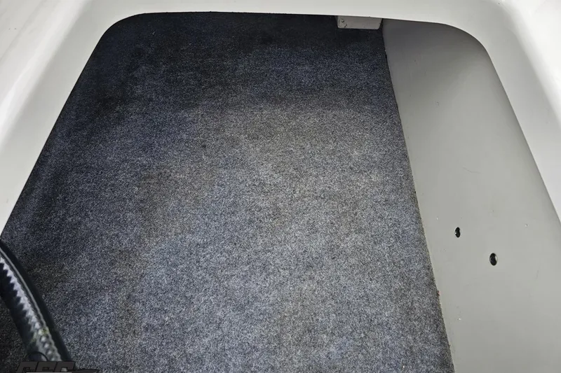 Slide: The Image of Carpeted interior of a 2022 Yamaha Boats AR195, showcasing clean flooring. - 89