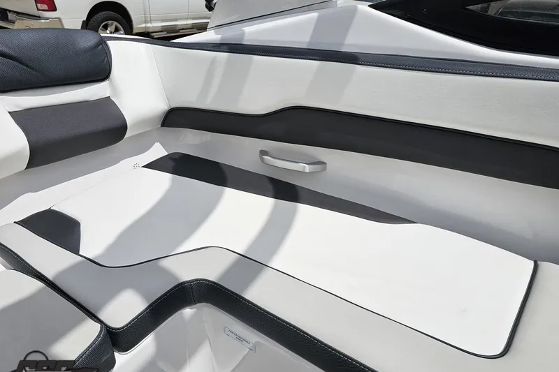 Slide: The Image of 2022 Yamaha Boats AR195 interior seating with sleek white and black design. - 90