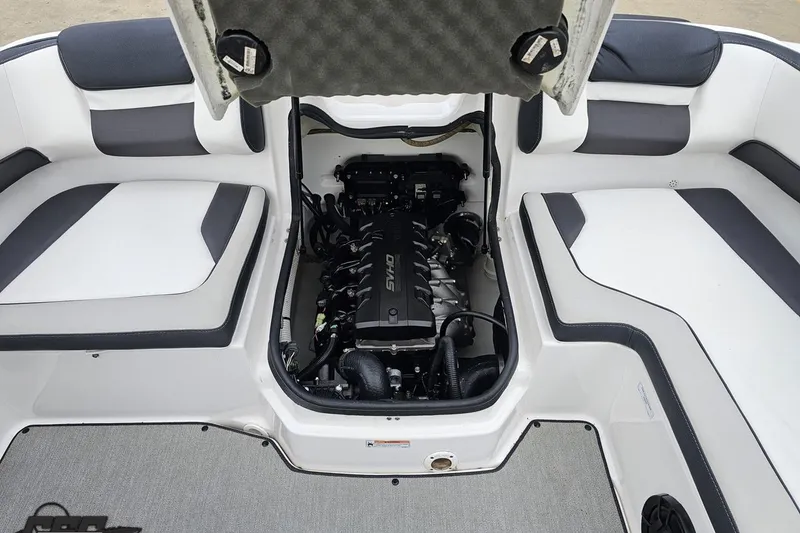 Slide: The Image of 2022 Yamaha Boats AR195 engine compartment with open hatch, showcasing interior seating. - 93