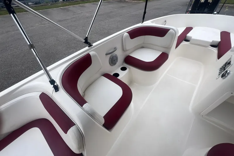 Slide: The Image of 2015 Bayliner Element XL boat interior with red and white seating. - 14