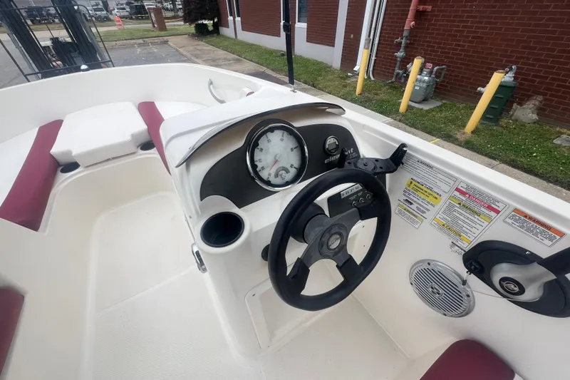 Slide: The Image of 2015 Bayliner Element XL boat dashboard with steering wheel and gauges. - 19