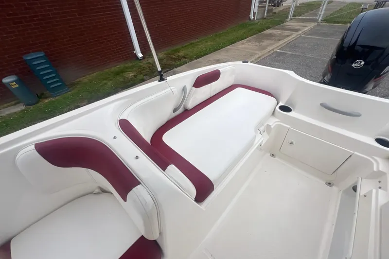 Slide: The Image of 2015 Bayliner Element XL boat interior with white and maroon seating. - 20