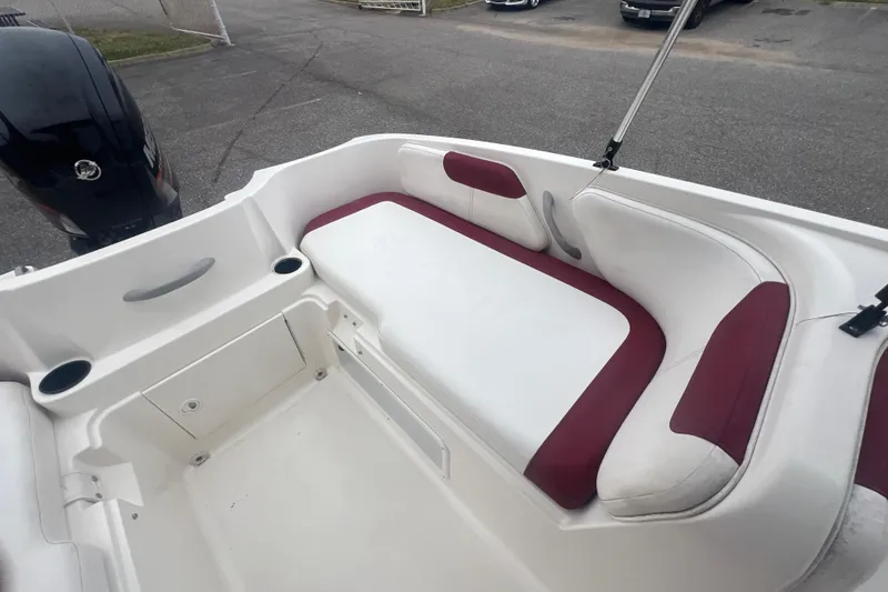 Slide: The Image of 2015 Bayliner Element XL boat interior with white and red seating, showcasing spacious design. - 21