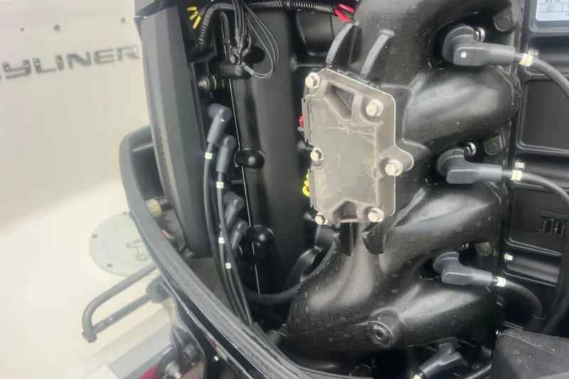 Slide: The Image of Close-up of a 2015 Bayliner Element XL engine components and wiring. - 26