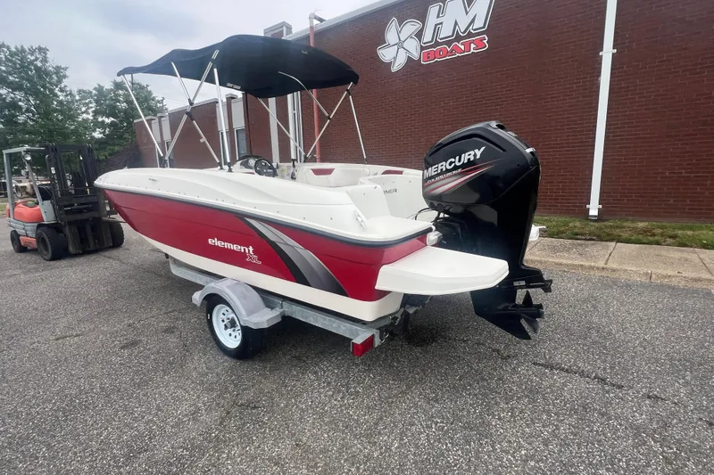 Slide: The Image of 2015 Bayliner Element XL boat with Mercury outboard motor on trailer. - 3