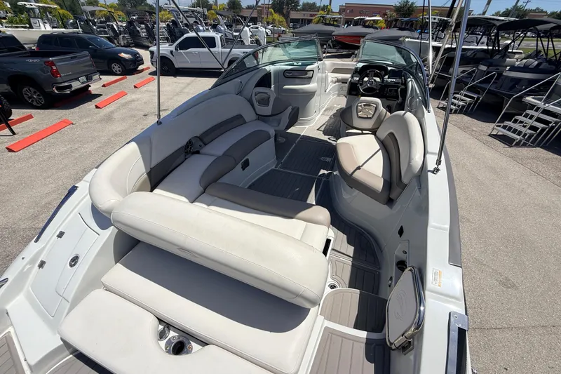 Slide: The Image of 2018 Crownline Eclipse E26 XS boat interior with plush seating and modern dashboard. - 11