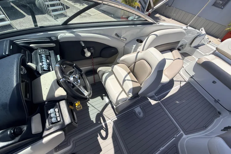 Slide: The Image of 2018 Crownline Eclipse E26 XS boat interior with steering wheel and seating. - 17
