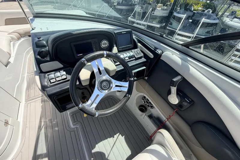 Slide: The Image of Cockpit view of 2018 Crownline Eclipse E26 XS boat with modern controls and steering wheel. - 22