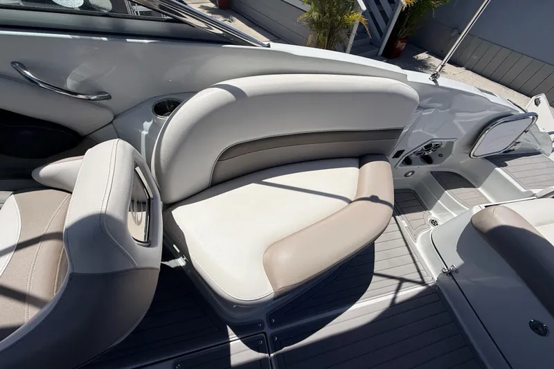 Slide: The Image of 2018 Crownline Eclipse E26 XS boat interior with beige and white seating. - 24