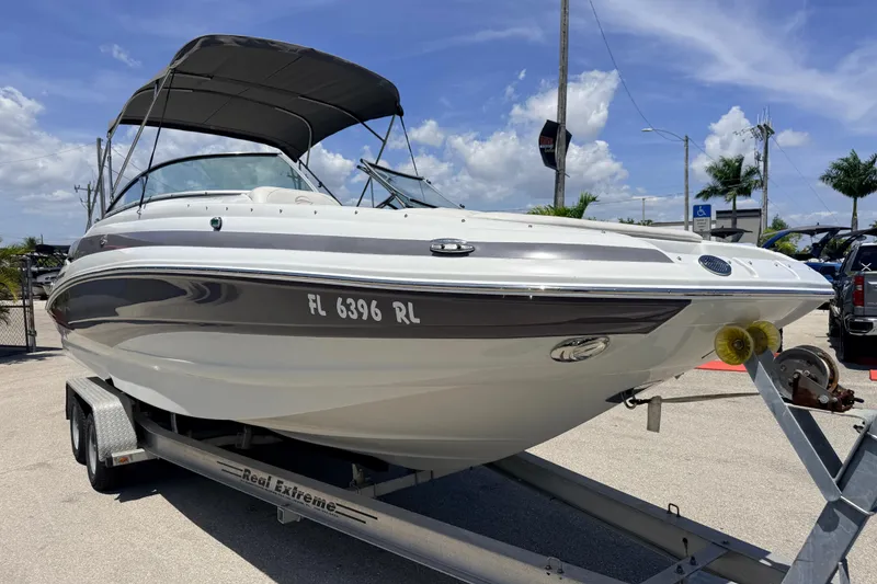 Slide: The Image of 2018 Crownline Eclipse E26 XS boat on trailer under clear blue sky. - 5