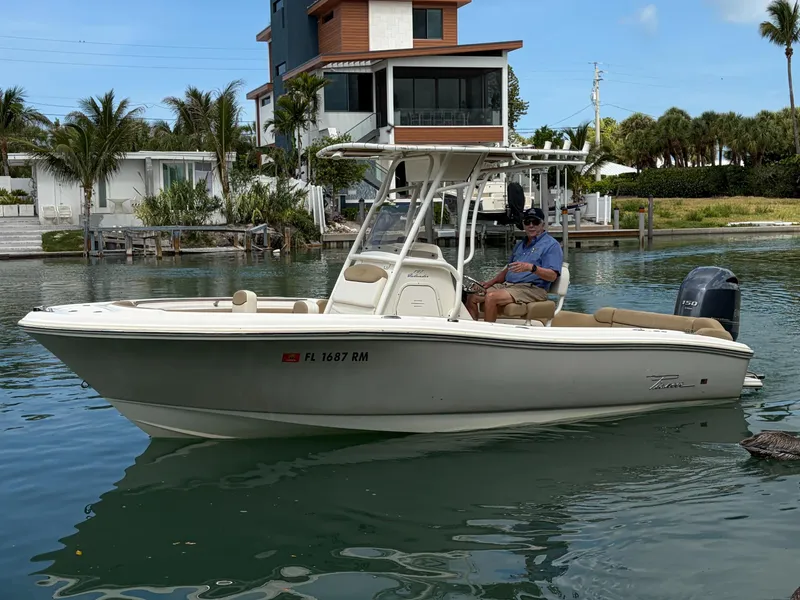 The Image of 2016 Pioneer 197 Islander boat on calm water near modern villa. - 1