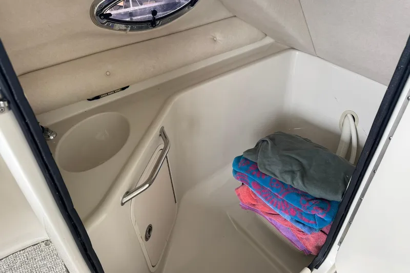 Slide: The Image of Interior of 2008 Sea Ray 240 Sundeck with sink and folded towels. - 14