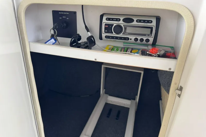 Slide: The Image of 2008 Sea Ray 240 Sundeck interior storage with stereo system and accessories. - 15