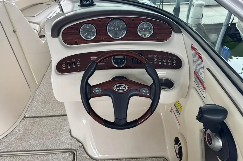 Slide: The Image of Steering console of a 2008 Sea Ray 240 Sundeck boat with wood accents. - 17