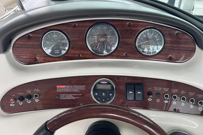 Slide: The Image of Dashboard of a 2008 Sea Ray 240 Sundeck boat with gauges and controls. - 18