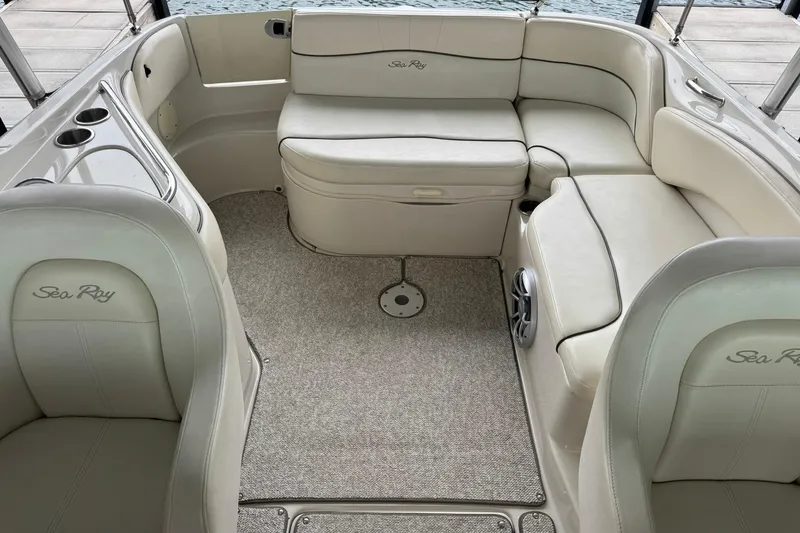 Slide: The Image of Interior of a 2008 Sea Ray 240 Sundeck boat with beige seating and carpet. - 20