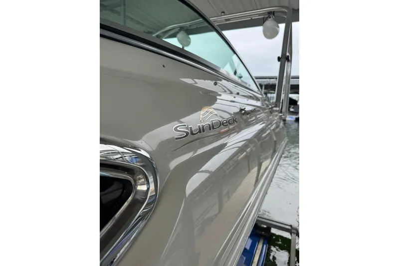 Slide: The Image of 2008 Sea Ray 240 Sundeck boat docked, showcasing sleek design and branding. - 6