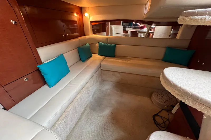 Slide: The Image of Luxurious interior of 2003 Sea Ray 340 Sundancer with beige seating and teal cushions. - 15