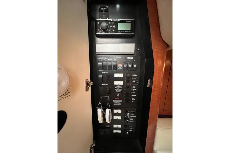 Slide: The Image of Control panel of a 2003 Sea Ray 340 Sundancer boat, featuring various switches and displays. - 16
