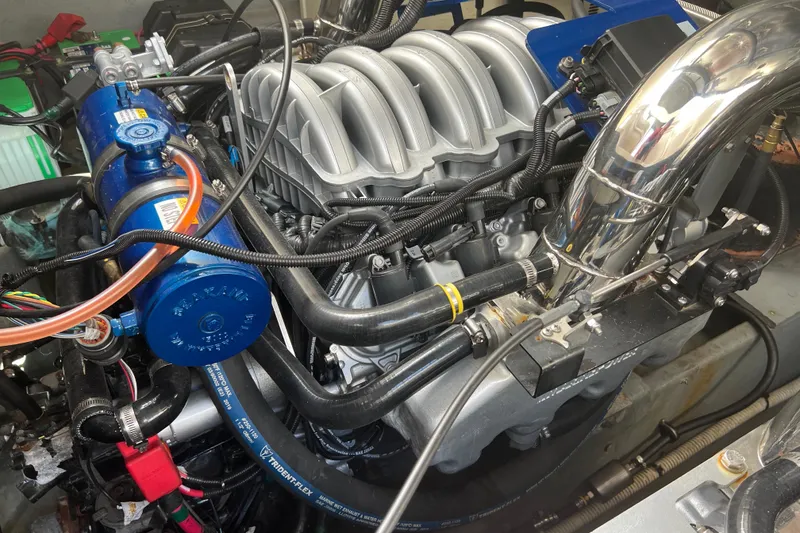 Slide: The Image of Engine compartment of a 2003 Sea Ray 340 Sundancer boat, showcasing detailed components. - 20
