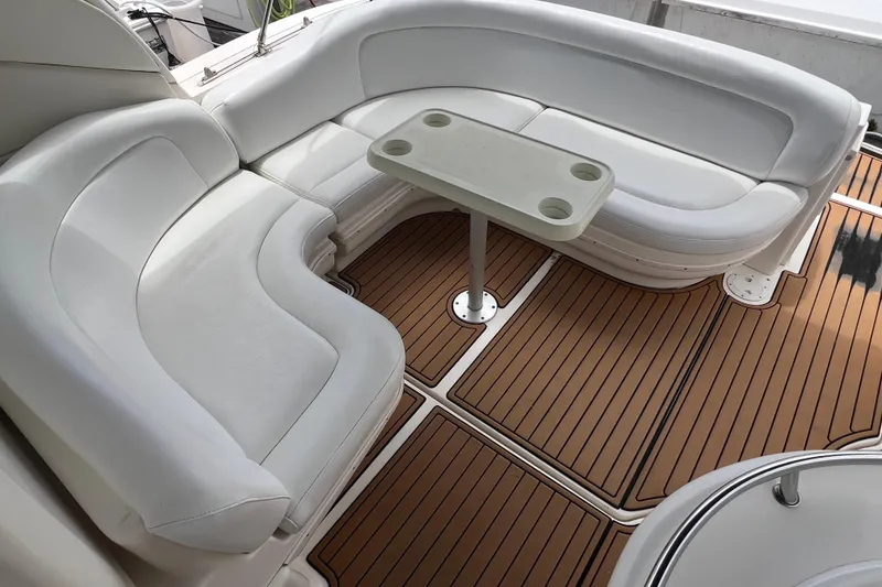 Slide: The Image of 2003 Sea Ray 340 Sundancer interior with white seating and wooden flooring. - 4