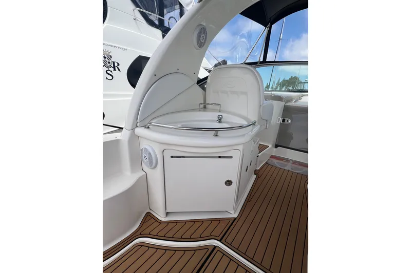Slide: The Image of 2003 Sea Ray 340 Sundancer cockpit with sink and teak flooring. - 5