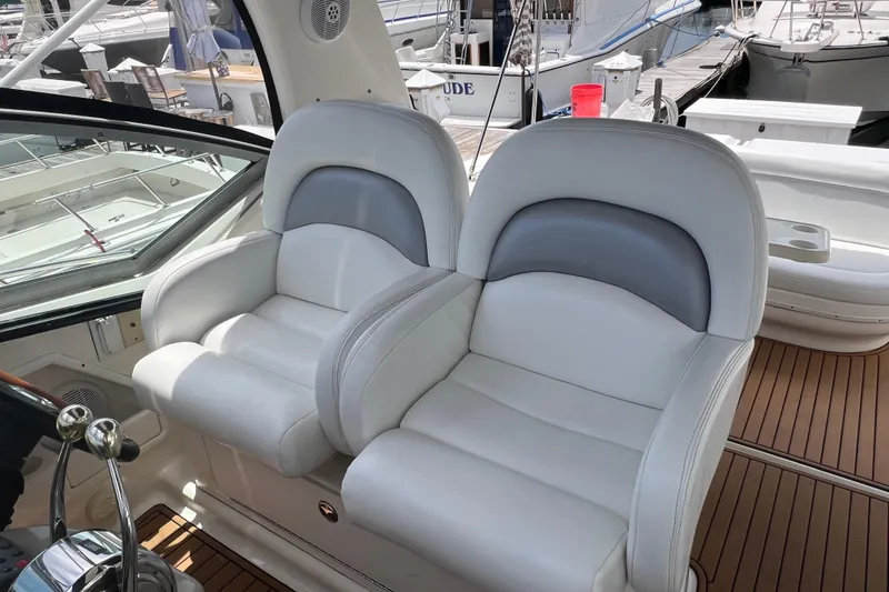 Slide: The Image of Luxury seating on a 2003 Sea Ray 340 Sundancer yacht, docked at a marina. - 8