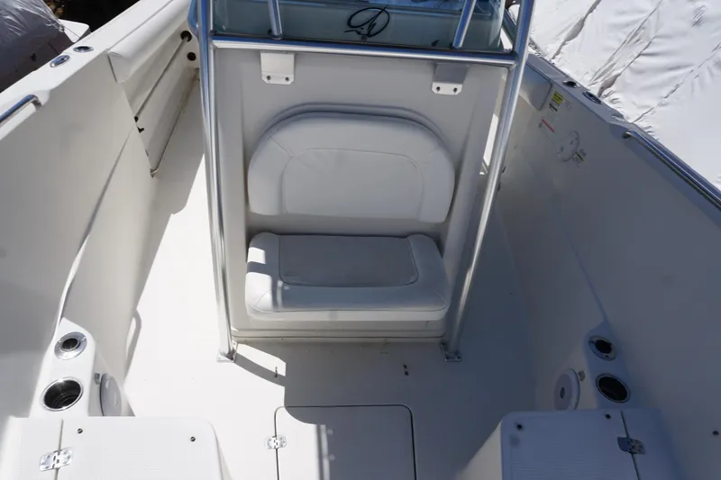 Slide: The Image of 2012 Sailfish 2380 CC boat interior with seating and cup holders. - 13
