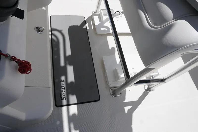 Slide: The Image of Interior of 2012 Sailfish 2380 CC boat featuring SeaDek flooring and seating area. - 16