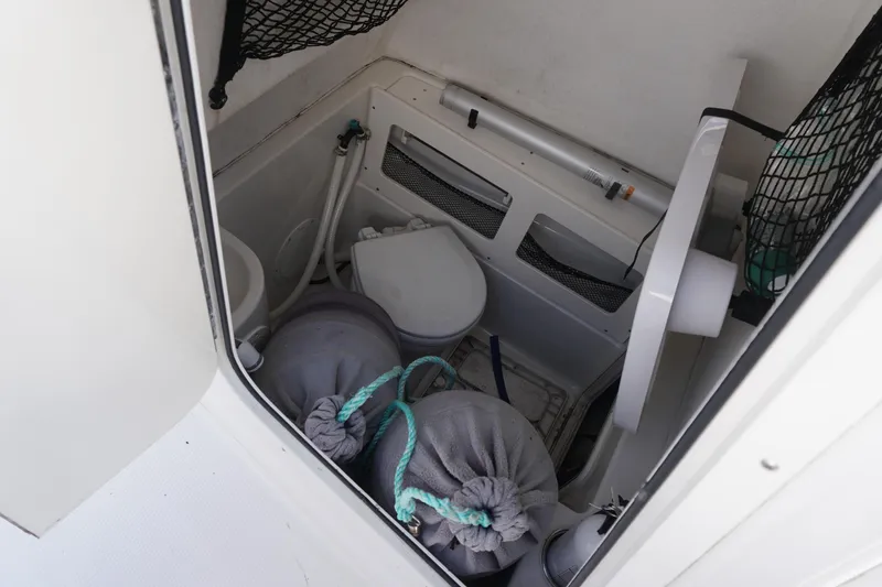 Slide: The Image of Interior of 2012 Sailfish 2380 CC boat showing storage and equipment. - 17