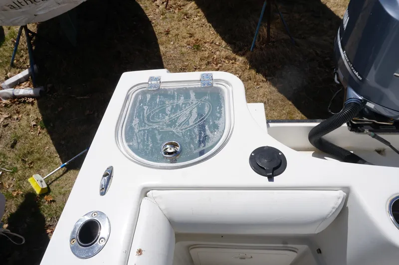 Slide: The Image of 2012 Sailfish 2380 CC boat deck with livewell and motor detail. - 22