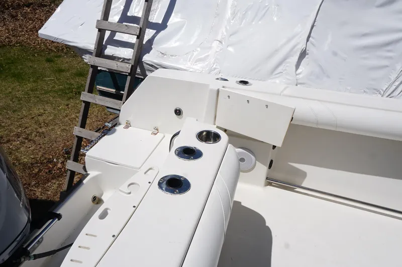 Slide: The Image of 2012 Sailfish 2380 CC boat interior with cup holders and seating area. - 23