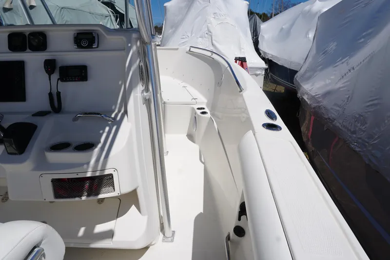 Slide: The Image of 2012 Sailfish 2380 CC boat interior with control panel and seating area. - 24