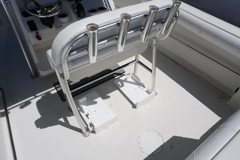 Slide: The Image of 2012 Sailfish 2380 CC boat interior with rod holders and steering console. - 6
