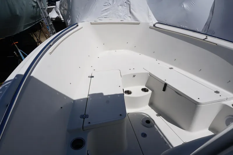 Slide: The Image of 2012 Sailfish 2380 CC boat interior with seating and storage compartments. - 9