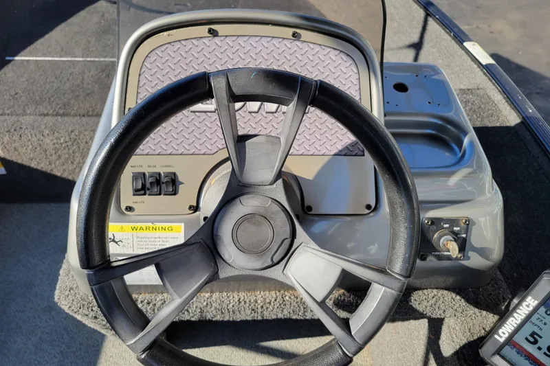 Slide: The Image of Steering wheel of 2017 Lowe Fishing Machine 160S boat with control panel. - 11