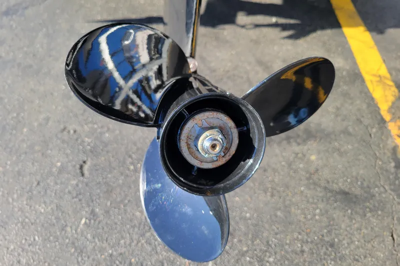 Slide: The Image of Close-up of a 2017 Lowe Fishing Machine 160S boat propeller on asphalt. - 17