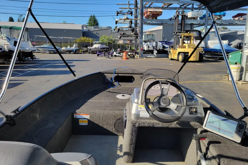 Slide: The Image of 2017 Lowe Fishing Machine 160S boat interior with steering wheel and control panel. - 8