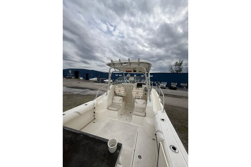 Slide: The Image of 2012 Boston Whaler 255 Conquest boat interior with overcast sky background. - 10
