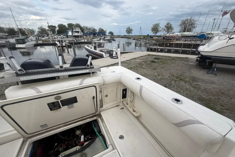 Slide: The Image of Boston Whaler 255 Conquest 2012 at marina with open engine compartment. - 12