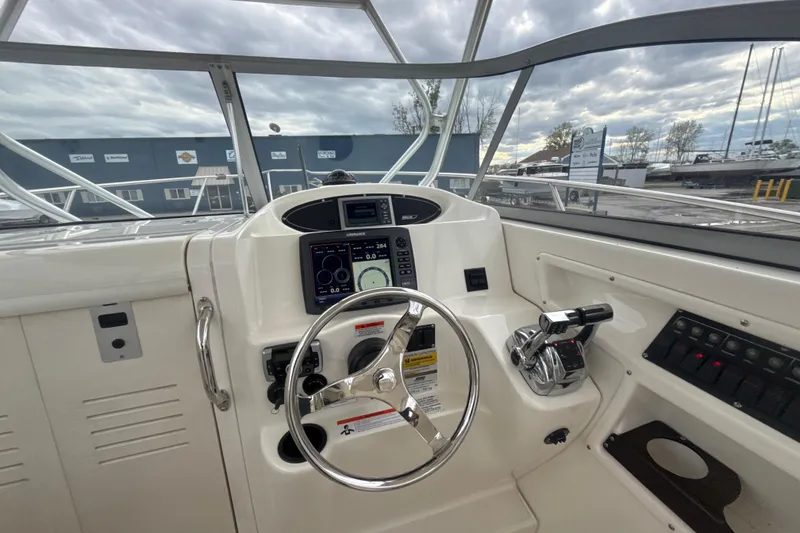 Slide: The Image of Helm of 2012 Boston Whaler 255 Conquest with steering wheel and control panel. - 14