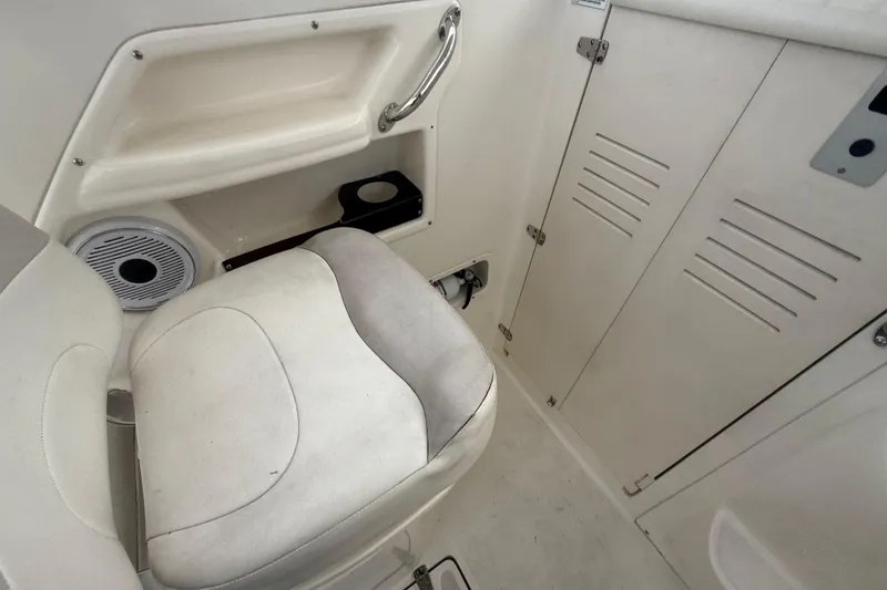 Slide: The Image of Interior of 2012 Boston Whaler 255 Conquest boat, featuring seating and storage compartments. - 15