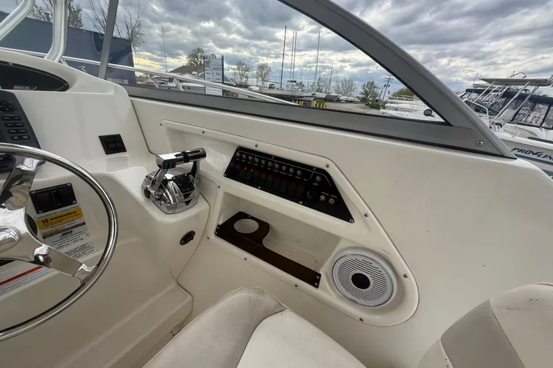 Slide: The Image of Interior view of 2012 Boston Whaler 255 Conquest boat cockpit with steering wheel and controls. - 17