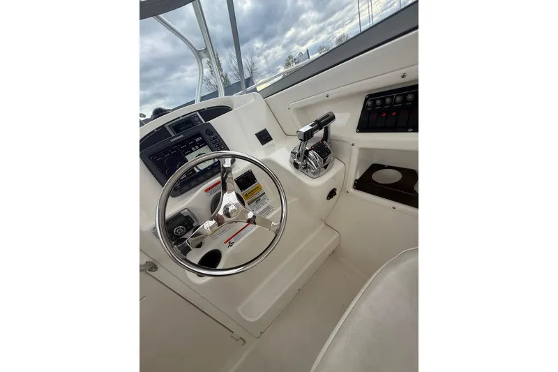 Slide: The Image of Helm of 2012 Boston Whaler 255 Conquest with steering wheel and controls. - 19