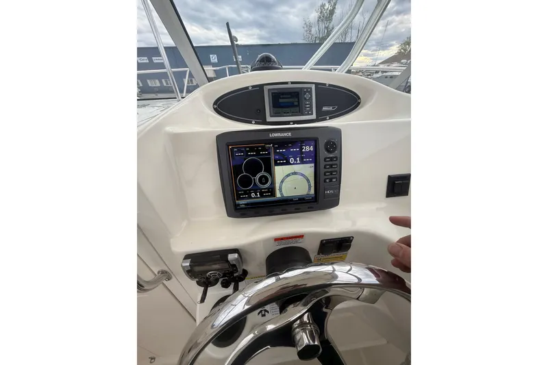 Slide: The Image of Boston Whaler 255 Conquest 2012 helm with navigation display and steering wheel. - 20
