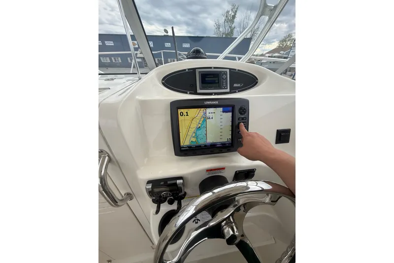 Slide: The Image of Helm of 2012 Boston Whaler 255 Conquest with navigation display and steering wheel. - 22