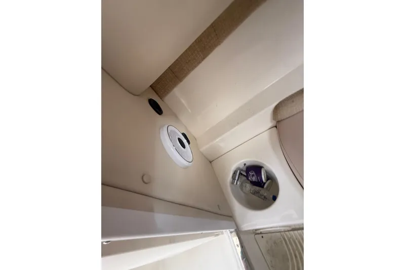 Slide: The Image of Interior view of a 2012 Boston Whaler 255 Conquest boat, featuring a cup holder and speaker. - 23